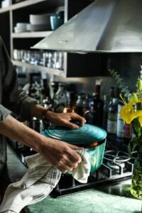 person holding cooking pot